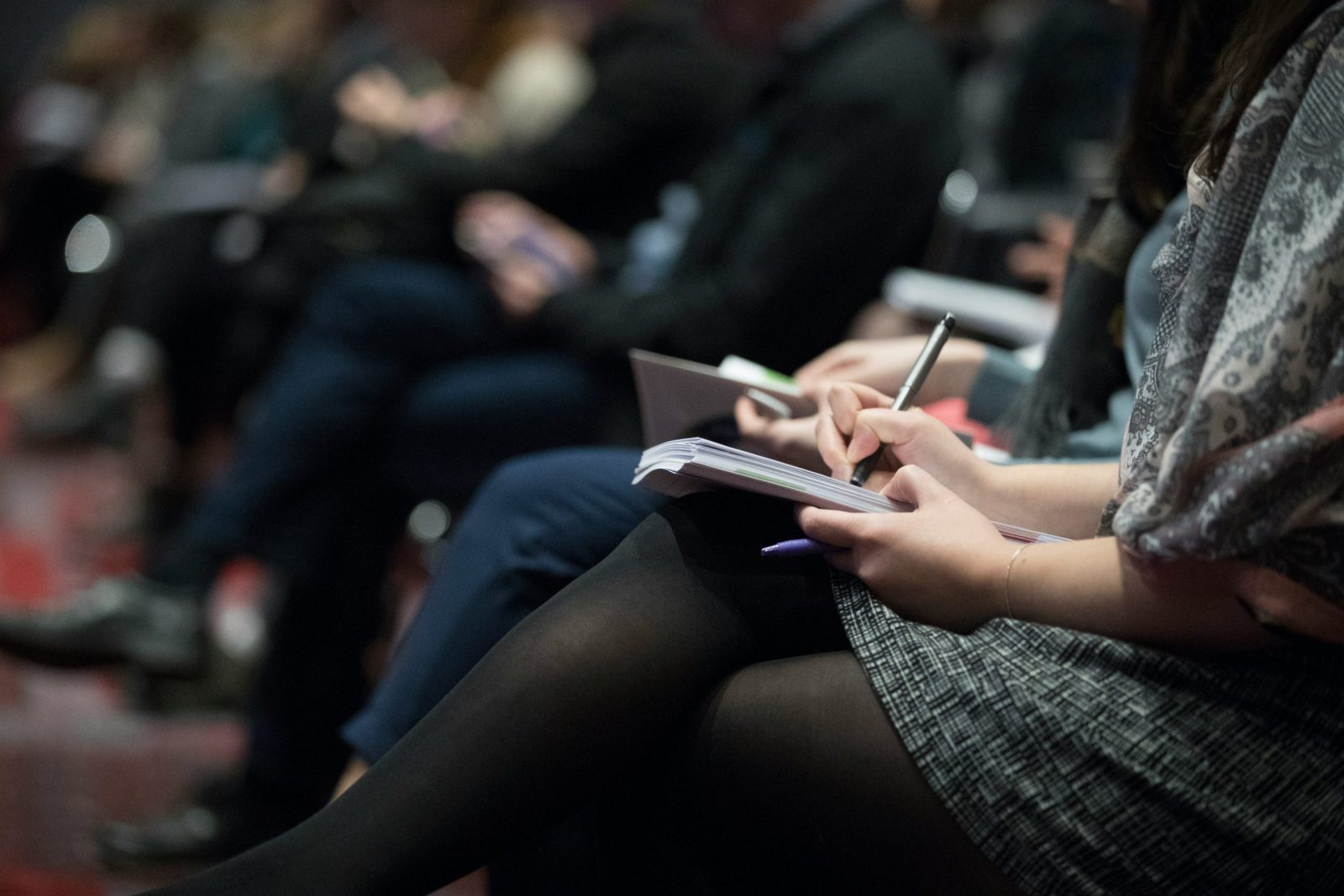 A closeup shot of students taking notes.